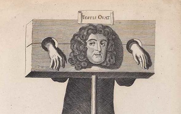 Titus Oates in the stocks with sign reading 'Testis Ovat' above his head.