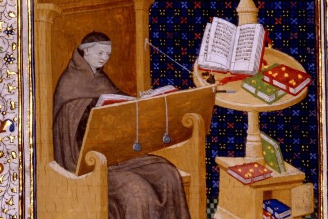 Guillaume de Deguileville seated with an open book on the desk before him which is kept open by strings and weights. 